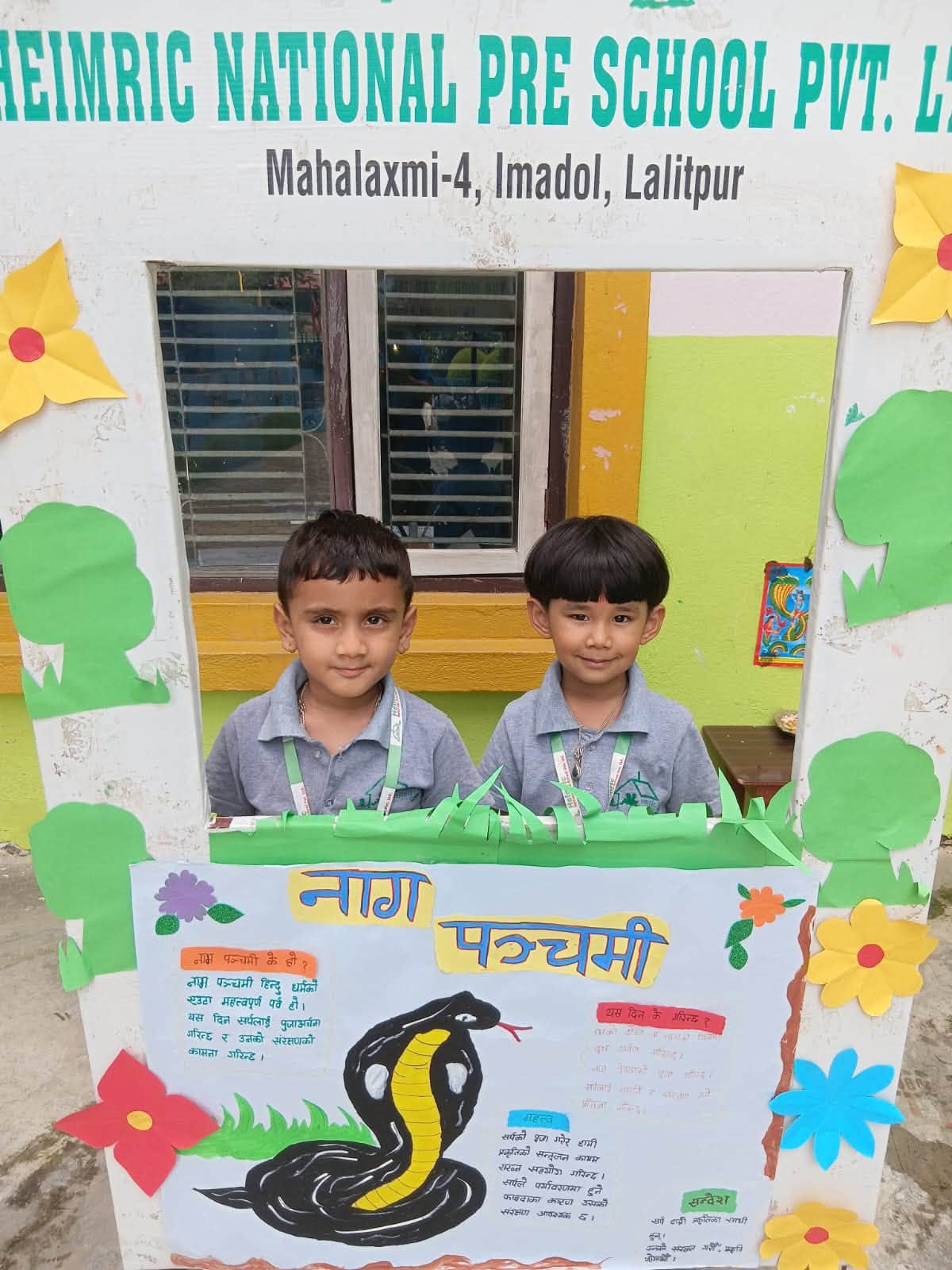 Two students at the Nag Panchami project display outside the school building