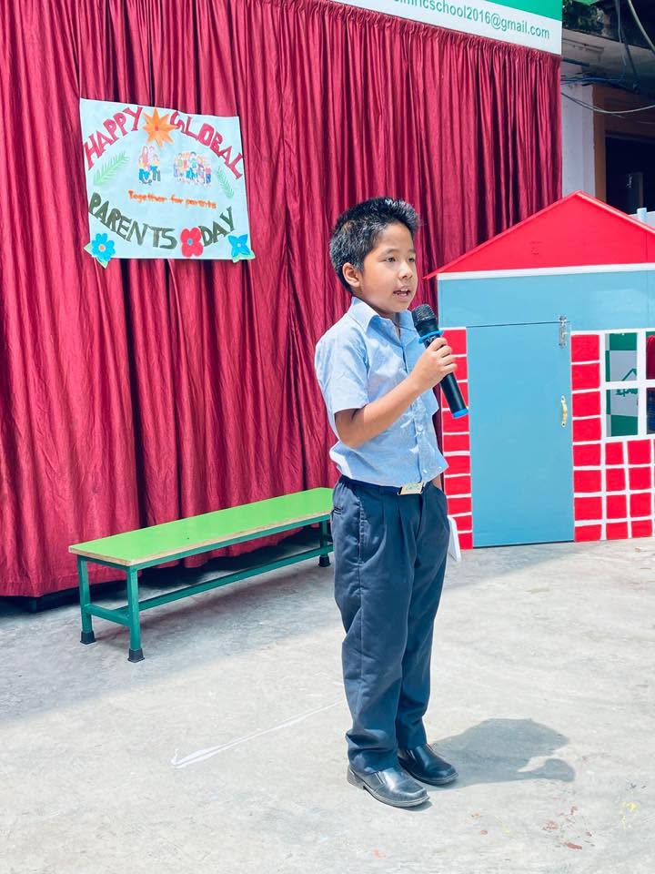 A young student speaking confidently into the microphone at Parents Day