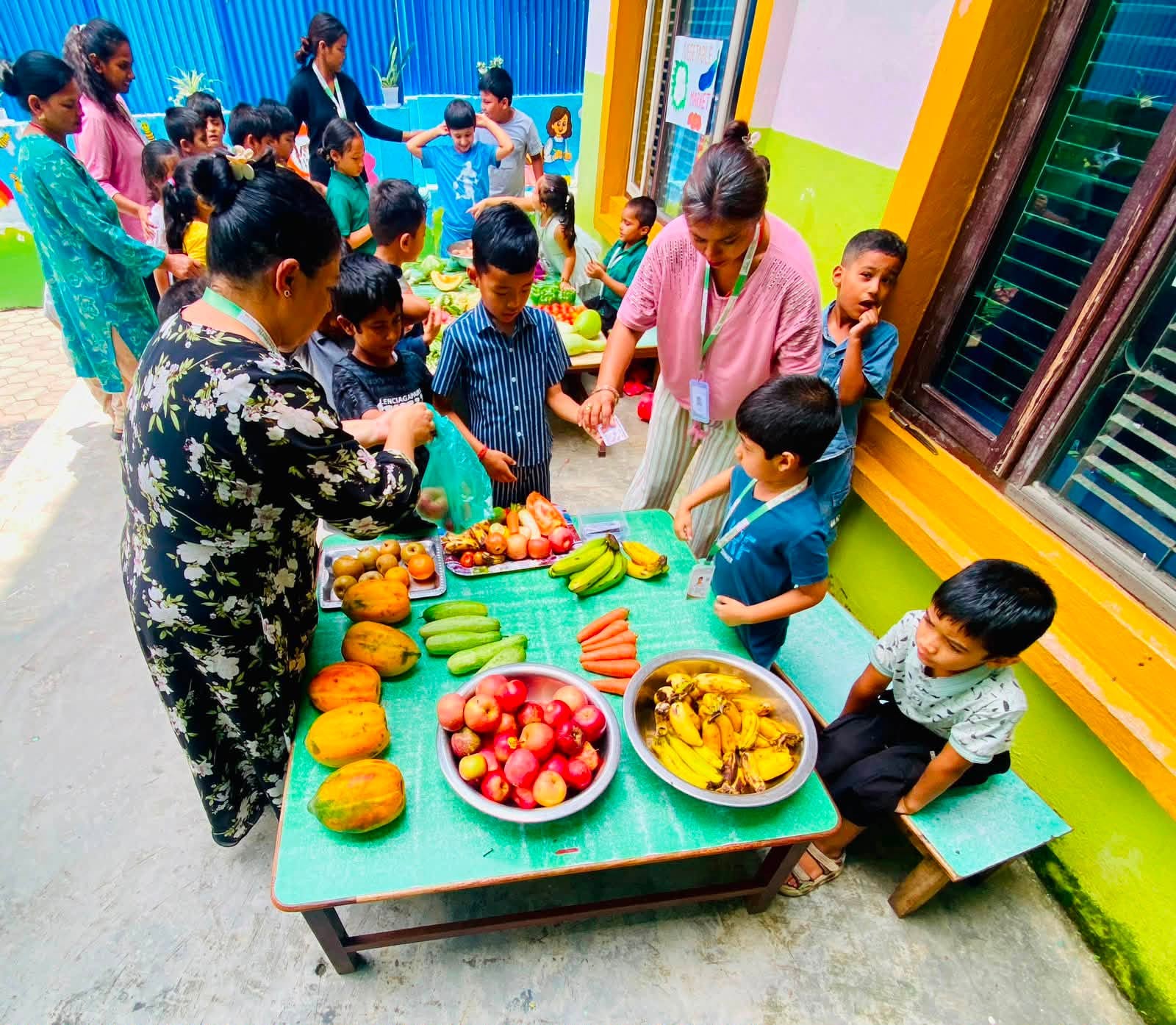 A teacher reading a picture book to a small circle of preschool children
